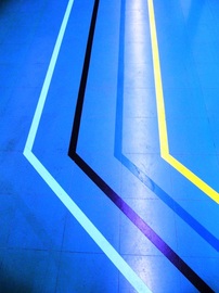 Sairaalan sinisellä lattialla neljä eri väristä viivaa kulkevat kulman kautta samaan suuntaan. Jan Holmberg Mainio -blogi janholmberg.weebly.com Copyright Jan Holmberg